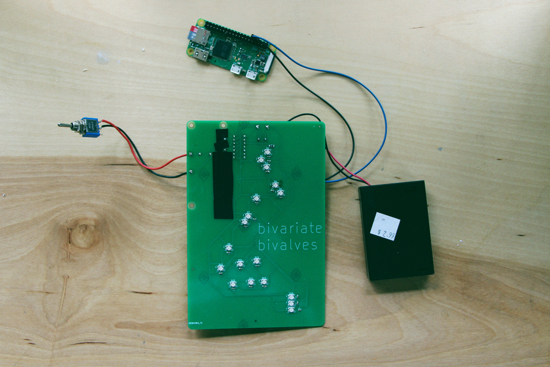 the printed circuit board that powers the LEDs, connected to a raspberry pi, a battery pack, and a switch